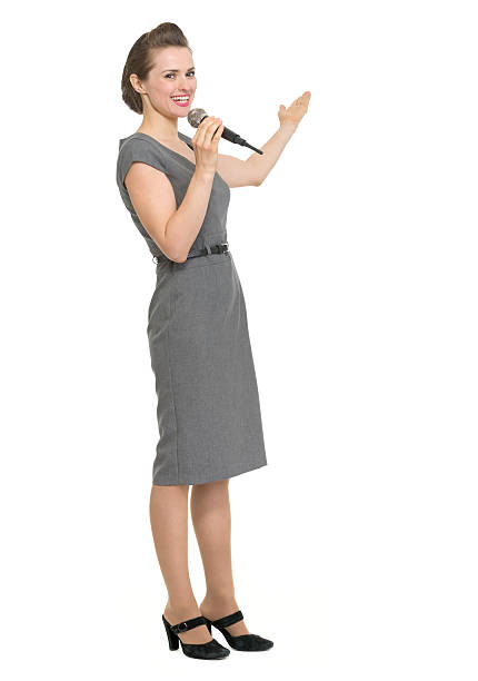 istock Woman reporter with microphone showing on copy space 475179976