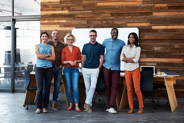 Teamwork makes the dream work Portrait of a group of coworkers standing together in an officehttp://195.154.178.81/DATA/i_collage/pu/shoots/804606.jpg organized group photos stock pictures, royalty-free photos & images