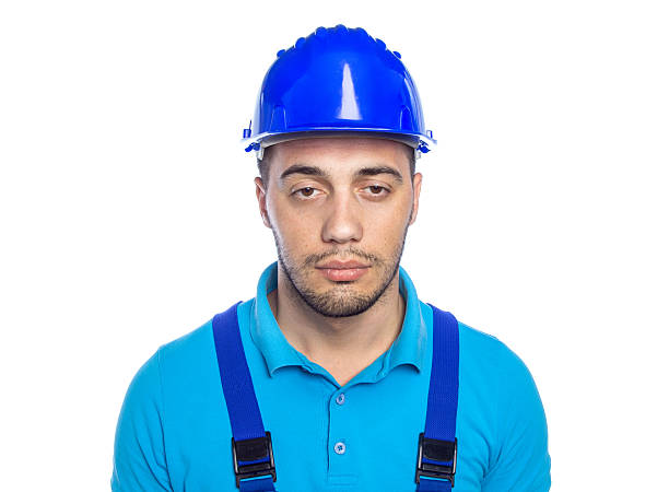 Builder - Construction Worker Lazy builder isolated on white background. Morose construction worker wearing hardhat lazy construction laborer stock pictures, royalty-free photos & images