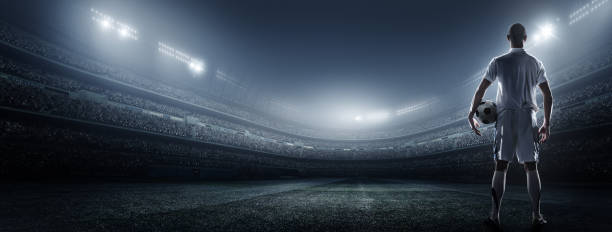 istock Soccer player with ball in stadium 475182606