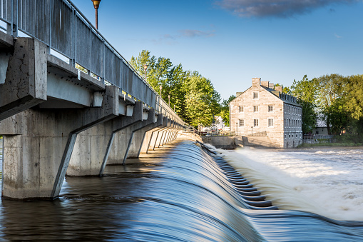 Historical Dam Site of Ile Des Moulins in the city of Terrebonne in Quebec, Canada on a nice summer day at sunset.
