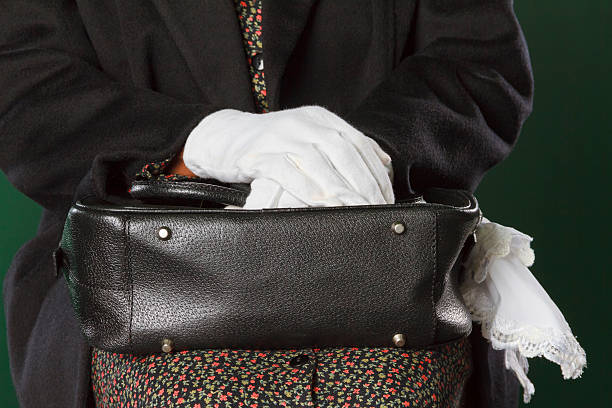 White Gloved Hands Holding Black Purse, Civil Rights stock photo