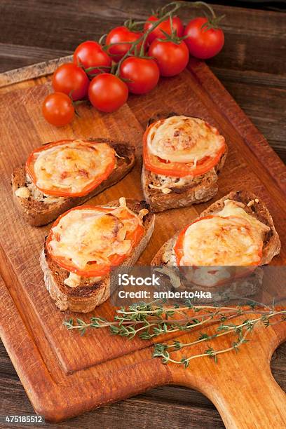 Italian Bruschetta On Wooden Table Stock Photo - Download Image Now - 2015, Antipasto, Baguette