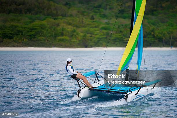 Young Woman Sailing On A Catamaran By The Caribbean Beach Stock Photo - Download Image Now