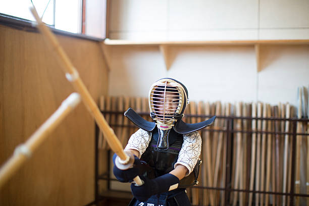 Kendo Student Kendo student practicing with shinai. kendo stock pictures, royalty-free photos & images