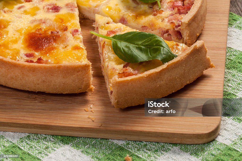 Hold. Tart with ham and bacon on a wooden board. 2015 Stock Photo