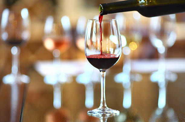 istock Red wine being poured into wineglass. 475189074