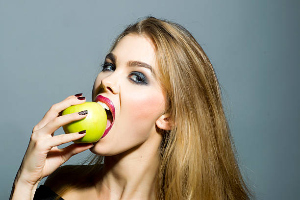 istock Sexual blonde girl with apple 475189442