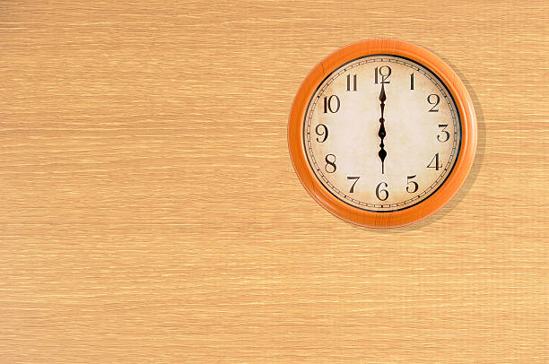 istock Clock showing 6 o'clock on a wooden wall 475189810