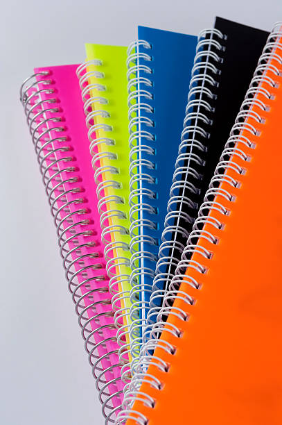カラーのスパイラルノート - orange education workbook spiral notebook ストックフォトと画像