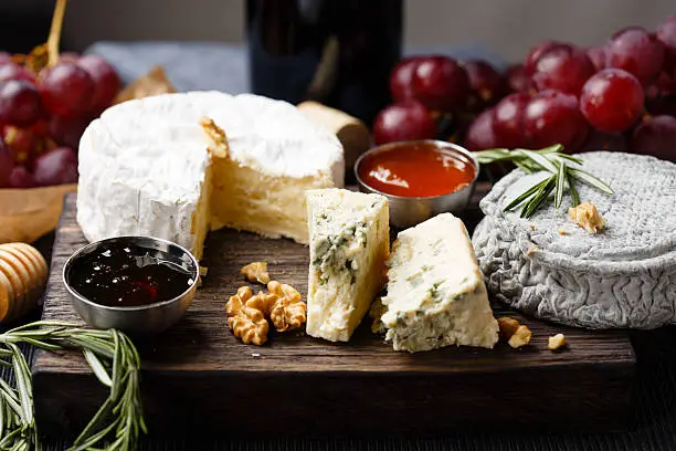 Photo of Cheese plate served with wine, jam and honey