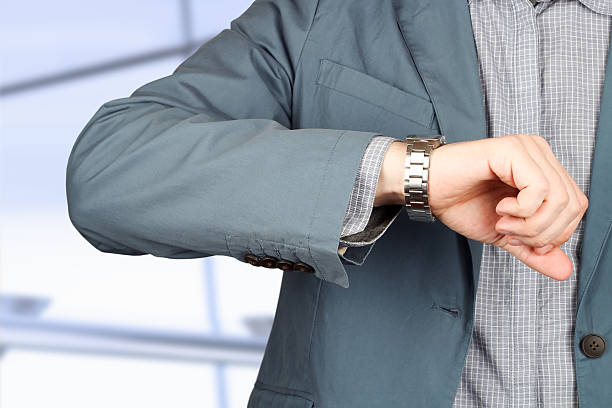 istock businessman checking time on his watch . 475194018