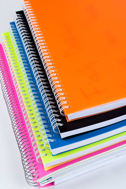 カラーのスパイラルノート - orange education workbook spiral notebook ストックフォトと画像