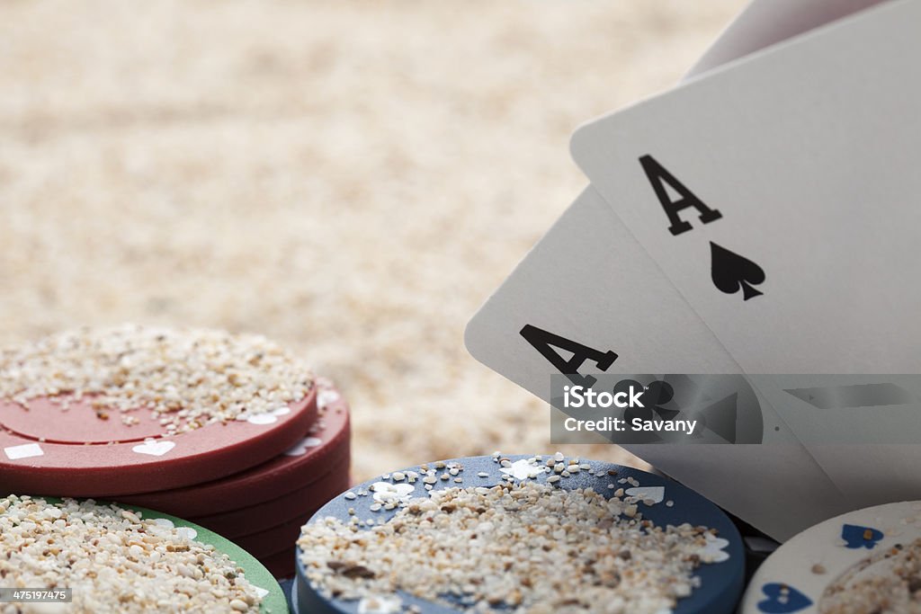 Poker Cards and chips photographed on sand Ace Stock Photo
