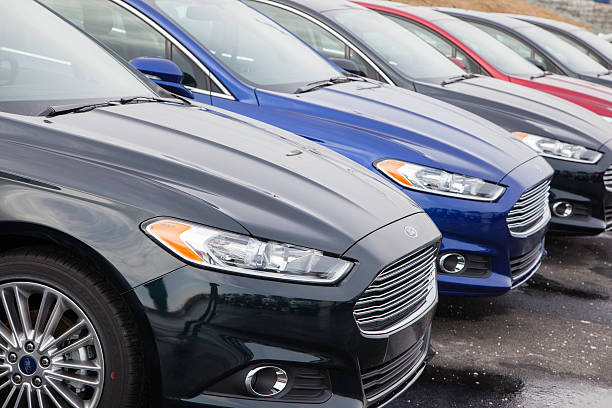 New Ford Fusion Vehicles Dartmouth, Nova Scotia, Canada - February 23, 2014: New Ford Fusion vehicles of multiple colors in a row at a car dealership showing front fascia of each vehicle. 2014 stock pictures, royalty-free photos & images