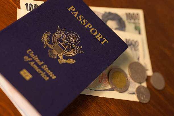 istock US passport with Japanese currency 475198644