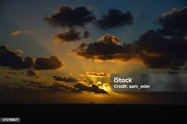 Glowing Sunset On Sea With Ship Stock Photo - Download Image Now - Backgrounds, Beach, Blue