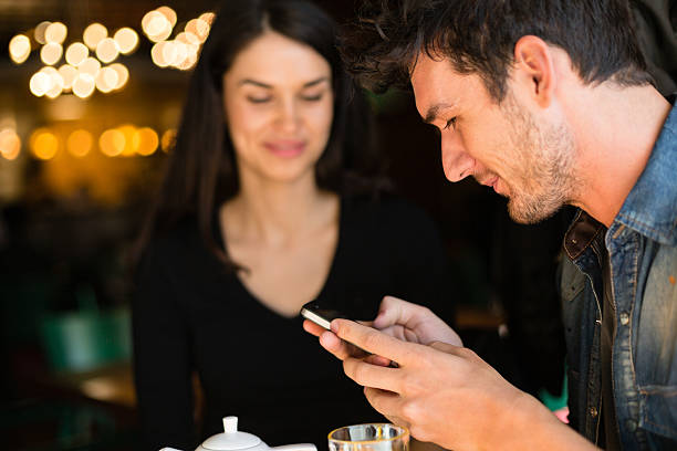 istock Happy couple in a cafe using mobile phone 475201039