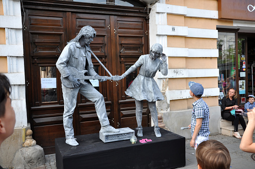Cluj Napoca, Romania - May 24, 2015: World Champions called Beeldje Living Statues from Netherland doing a busking mime called Sing along inside the Man.In.Fest during the Cluj Days
