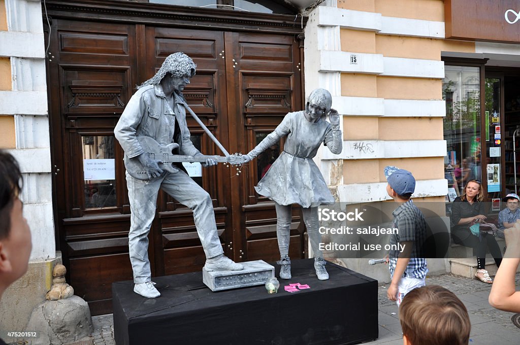 Beeldje Living Statues the World Champions of Living Statues Cluj Napoca, Romania - May 24, 2015: World Champions called Beeldje Living Statues from Netherland doing a busking mime called Sing along inside the Man.In.Fest during the Cluj Days 2015 Stock Photo