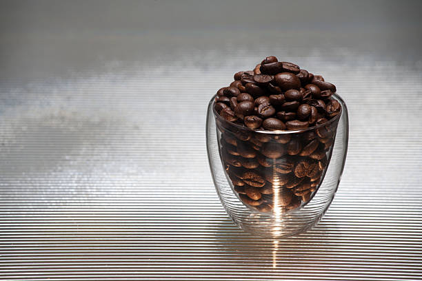 istock Glass with coffee grains on a color background. 475202581
