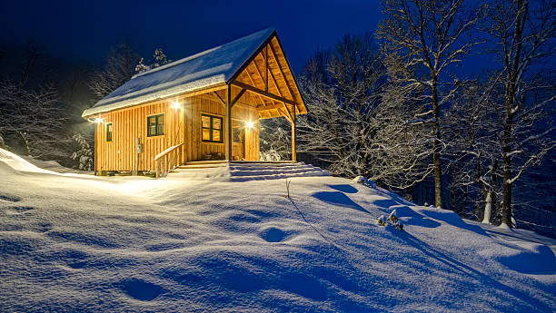 istock Rustic cabin in winter blizzard snowstorm at night 475203175