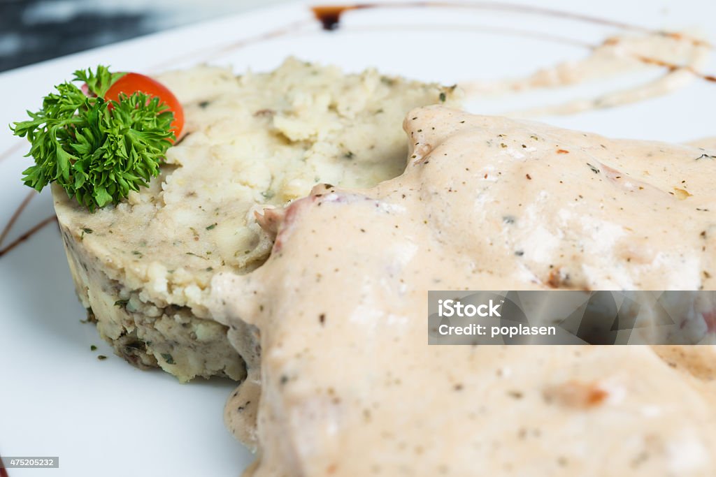 Meat with cream sauce, close up Meat in white sauce on a plate, close up 2015 Stock Photo