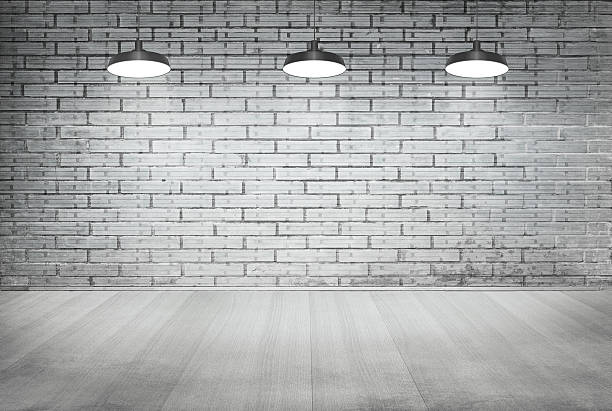 istock white brick grunge wall and wood floor with ceiling lamp 475206332