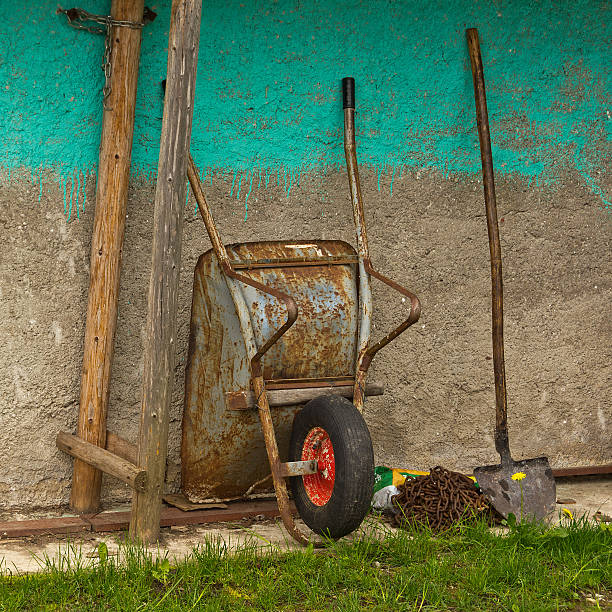 istock wheelbarrow and shovel 475207260