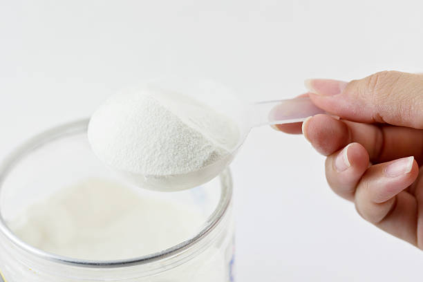 istock Collagen protein powder on spoon measure isolate on white backgr 475211096