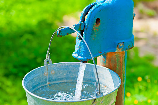 istock old rusty wheel and a bucket of clean water 475211131