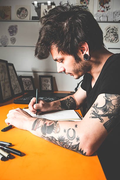 istock Tattoo Artist Drawing 475211144
