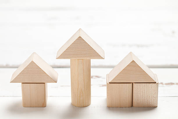 istock Wooden toy house on white table 475211684