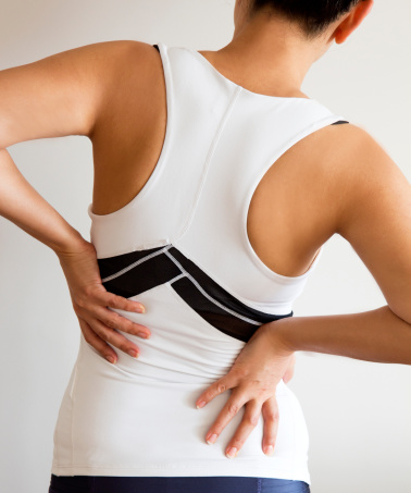 Woman with back pain, vertical