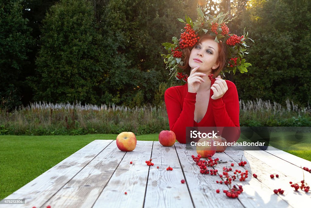 Nature Attractive young woman with flower wreath on her head with sunset in background. 2015 Stock Photo