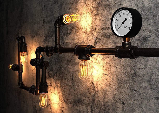 istock Light bulbs and metal pipes on the old cement wall 475217464