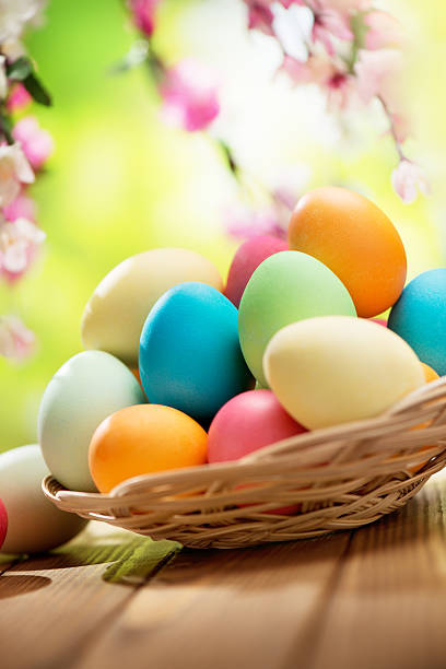 istock Colorful easter eggs and spring flowers on green nature background 475218307