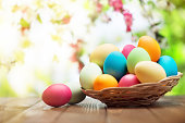 Colorful easter eggs and spring flowers on green nature background