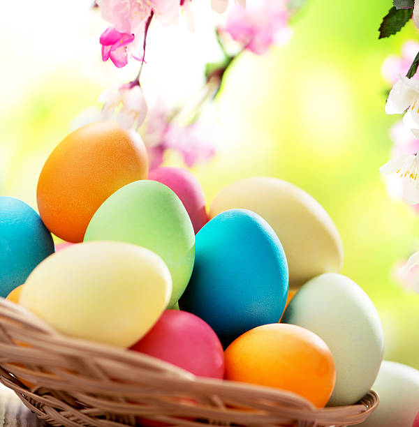 istock Colorful easter eggs and spring flowers on green nature background 475218323