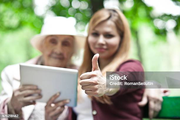 Grandmother And Granddaughter Approve The Technology Tablet Show Thumb Stock Photo - Download Image Now