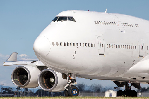 Boeing 747 also known as a jumbo jet lines up on a runway in preparation for takeoff. 
