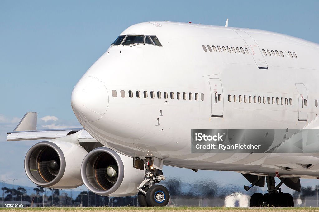 Jumbo Jet Boeing 747 also known as a jumbo jet lines up on a runway in preparation for takeoff.  Airplane Stock Photo