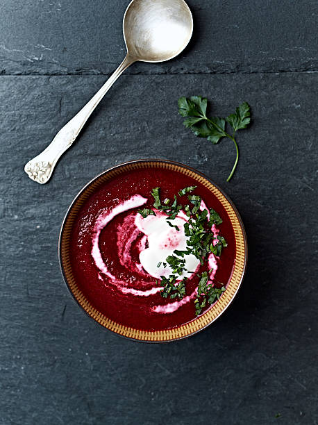 Cream of beetroot soup with cream and fresh parsley stock photo