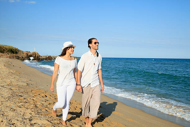 istock Young couple walking on the beach 475222002