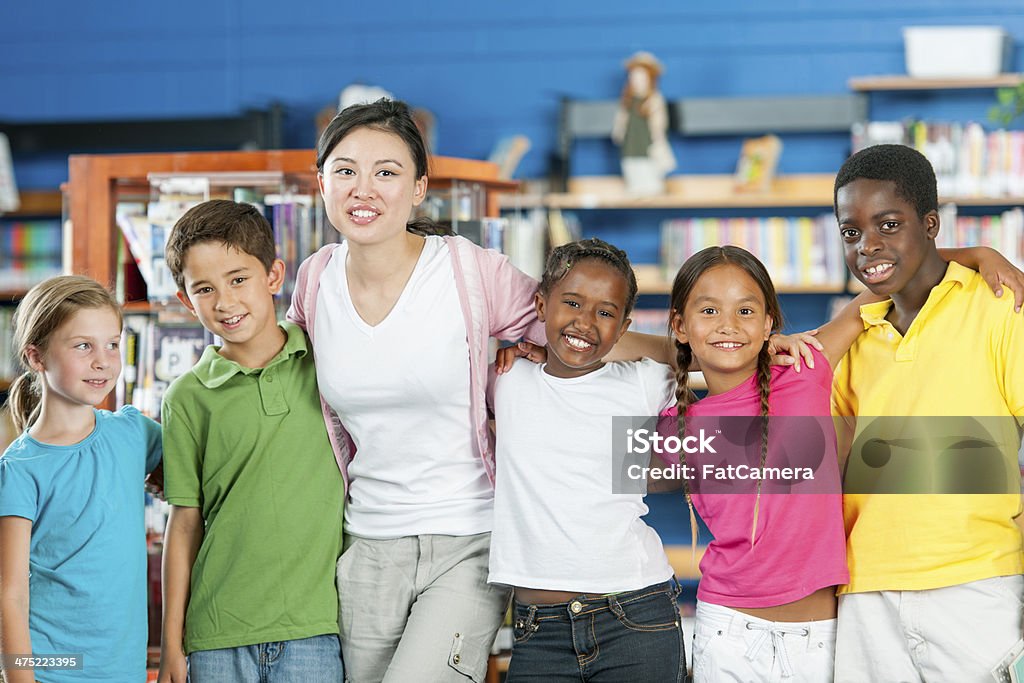 Library Diverse group of elementary school students in the library. Adult Stock Photo