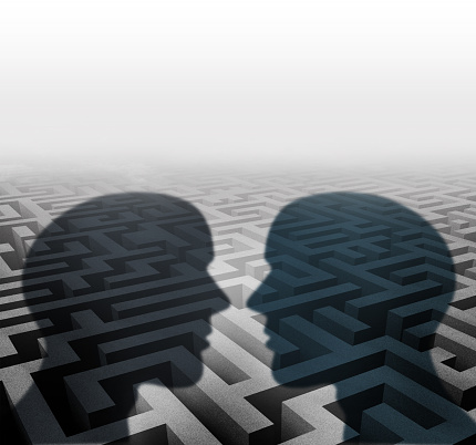Relationship concept for group therapy or marriage counseling or employee relations as two human head shadows on a maze facing together as an icon of partnership solutions and personal crisis management.