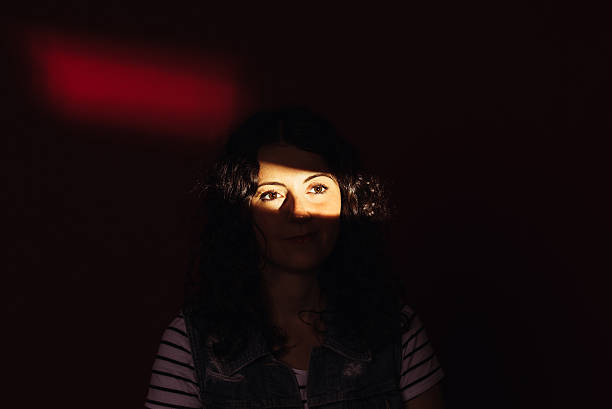istock Beautiful Young Woman Looking Through Window 475224212