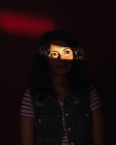 istock Beautiful Young Woman Looking Through Window 475224216