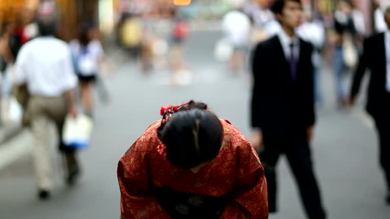 Japanese Girl in a Kimono Bowing in Shibuya