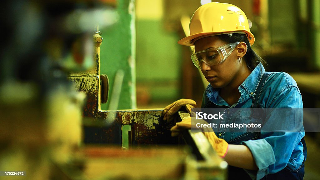 Hard work Female worker looking at container Manufacturing Occupation Stock Photo